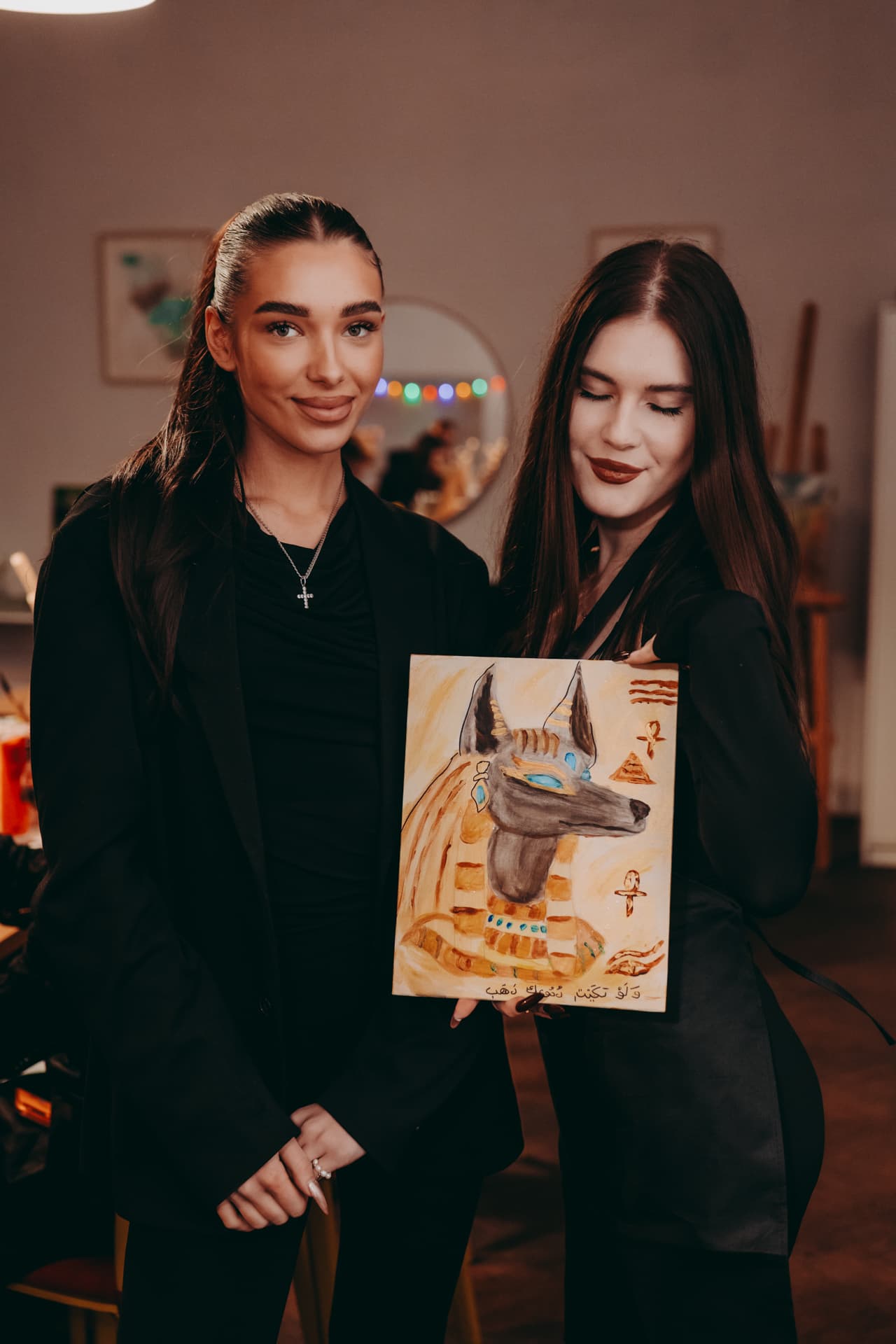Finished painting held by a workshop guest