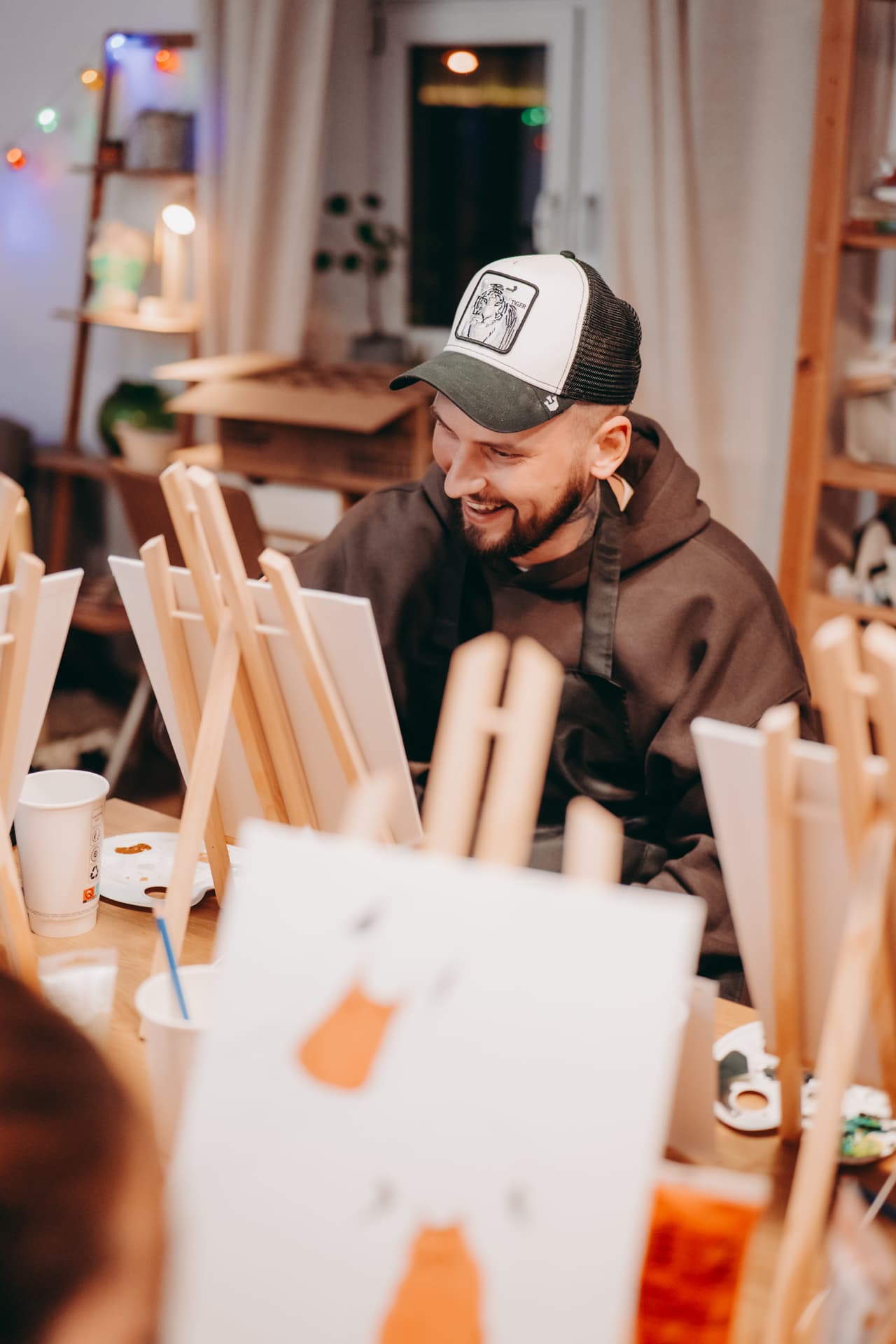 Guests enjoying wine while painting